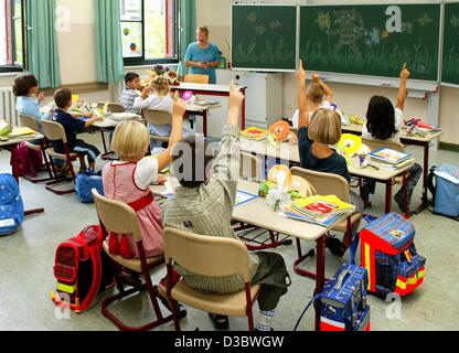 (dpa) - The first graders attend their first lesson on their first day at school in Magdeburg, Germany, 23 August 2003. In eastern Germany, the number of students is decreasing steadily. The reasons are the decreasing birthrate and that many of the young people move away to the western states to fin Stock Photo