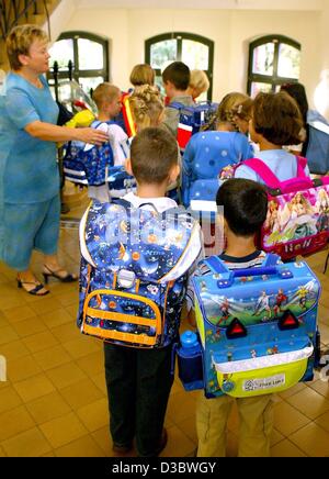 (dpa) - A group of first graders are on their way to their first lesson at an elementary school in Magdeburg, eastern Germany, 23 August 2003. In eastern Germany, the number of students is decreasing steadily. The reasons are the decreasing birthrate and that many of the young people move away to th Stock Photo