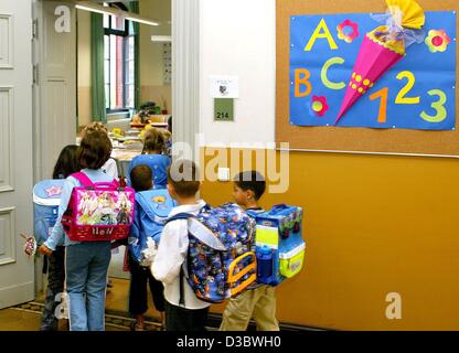 (dpa) - A group of first graders are on their way to their first lesson at an elementary school in Magdeburg, eastern Germany, 23 August 2003. In eastern Germany, the number of students is decreasing steadily. The reasons are the decreasing birthrate and that many of the young people move away to th Stock Photo