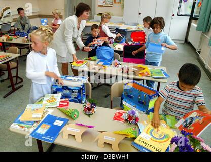 (dpa) - The first graders attend their first lesson on their first day at school in Magdeburg, Germany, 23 August 2003. In eastern Germany, the number of students is decreasing steadily. The reasons are the decreasing birthrate and that many of the young people move away to the western states to fin Stock Photo