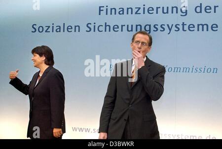 (dpa) - German Health Minister Ulla Schmidt (L) and Bert Ruerup, Chairman of the commission of inquiry, stand underneath the title 'financing of the social security systems' at a press conference in Berlin, 28 August 2003. Painful changes to Germany's cradle-to-the-grave welfare state were recommend Stock Photo