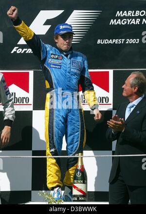 (dpa) - Spain's Fernando Alonso of Renault celebrates on the podium after winning the Hungarian Grand Prix in Budapest, 24 August 2003. Alonso made Formula One history by becoming the youngest driver to win a Grand Prix when he led the Hungarian Grand Prix from start to finish. Alonso, who turned 22 Stock Photo