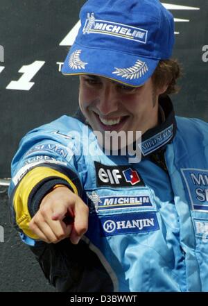 (dpa) - Spain's Fernando Alonso of Renault celebrates on the podium after winning the Hungarian Grand Prix in Budapest, 24 August 2003. Alonso made Formula One history by becoming the youngest driver to win a Grand Prix when he led the Hungarian Grand Prix from start to finish. Alonso, who turned 22 Stock Photo