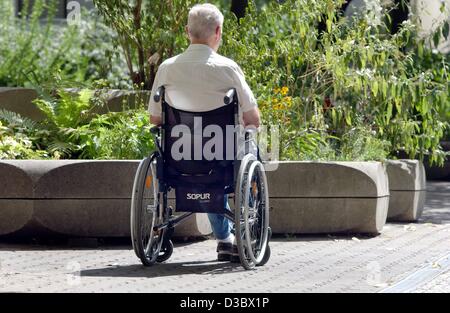 (dpa) - An elderly man in a wheelchair sits lonely on a terrace in Berlin, 21 August 2003. According to newspaper reports the legal pensions will drop from now 48 per cent of the gross income to 40.1 per cent by 2030. Stock Photo