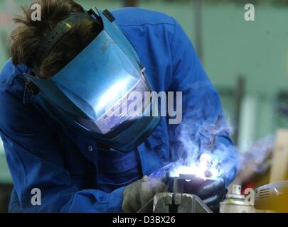 (dpa) - A worker welds in the metal construction company Erwin Kostyra in the district of Pankow in Berlin, 24 June 2003. The sluggish economy hits mostly the small and medium sized companies in Germany. Between January and June 2003 about 19,200 companies filed for insolvency, according to figures  Stock Photo