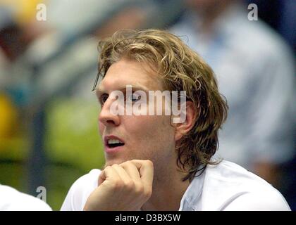 (dpa) - German national basketball player Dirk Nowitzki watches his team play during the friendly game against Turkey in Frankfurt, Germany, 16 August 2003. Germany won the test game ahead of the European Championships 78-64.  Nowitzki, who plays for the Dallas Mavericks in the U.S., will take part  Stock Photo