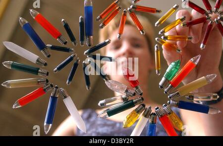 (dpa) - An employee lays out a variety of low voltage light bulbs of different shapes and colours at the production site of the light bulb manufacturer Narva-Golux in Oberweissbach, Germany, 11 June 2003. The small light bulbs are used for car lights, signal lights, illuminations and glass light dec Stock Photo