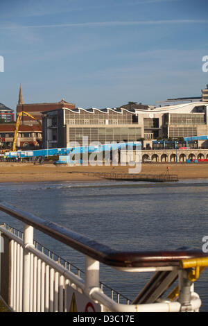 Bournemouth, UK 15 February 2013. The bulldozers start tearing down the glass front of one of the most hated buildings in the UK, the Imax complex building on Bournemouth seafront. Once demolished, the site will be turned into an open-air events arena, ready for the summer season. Stock Photo