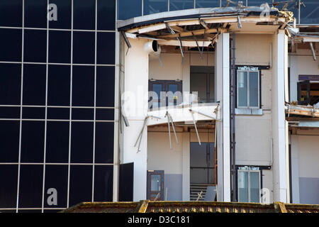 Bournemouth, UK 15 February 2013. The bulldozers start tearing down the glass front of one of the most hated buildings in the UK, the Imax complex building on Bournemouth seafront. Once demolished, the site will be turned into an open-air events arena, ready for the summer season. Stock Photo