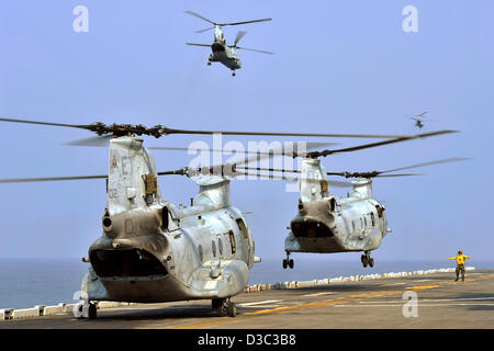 US Navy CH-46E Sea Knight helicopters take off from the amphibious assault ship USS Bonhomme Richard February 14, 2013 in the Gulf of Thailand. The Bonhomme Richard Amphibious Ready Group is taking part in Cobra Gold, a Thai-U.S. joint exercise. Stock Photo