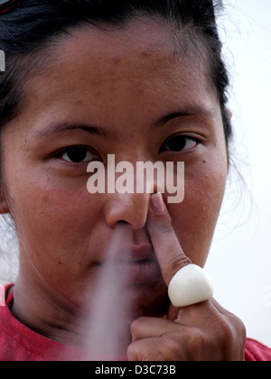 Woman blowing hookah smoke out of nose in Dahab, Egypt. Stock Photo