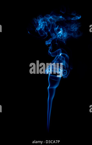 blue rings and curls of smoke on black background Stock Photo