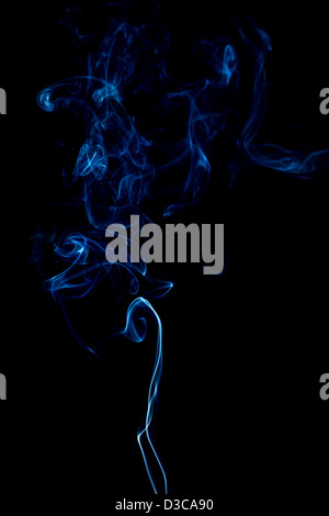 blue rings and curls of smoke on black background Stock Photo