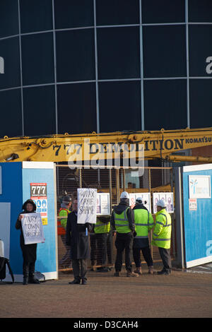 Bournemouth, UK 15 February 2013. The bulldozers start tearing down the glass front of one of the 'most hated buildings' in the UK, the Imax complex building on Bournemouth seafront. Once demolished, the site will be turned into an open-air events arena, ready for the summer season. Credit Carolyn Jenkins/Alamy Live News Stock Photo