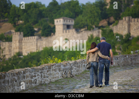 Bulgaria, Europe, Veliko Tarnovo, Hilltop Fortress Of Tsarevets, Couple Strolling Around The Wall. Stock Photo