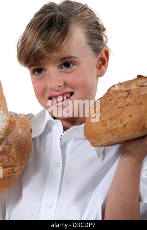 Girl with loaves of bread Stock Photo