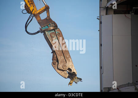 Bournemouth, UK 15 February 2013. The bulldozers start tearing down the glass front of one of the most hated buildings in the UK, the Imax complex building on Bournemouth seafront. Once demolished, the site will be turned into an open-air events arena, ready for the summer season. Stock Photo