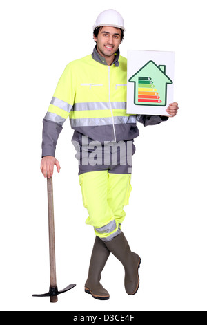 handsome heating engineer with hand resting on pickaxe Stock Photo