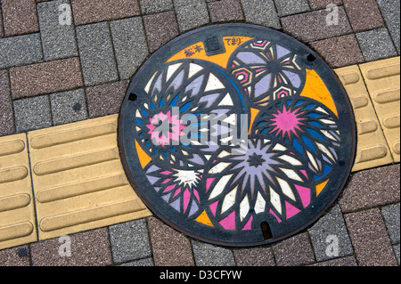 Colorful manhole cover art depicting Japanese temari thread ball arts and crafts in Matsumoto, Nagano. Stock Photo
