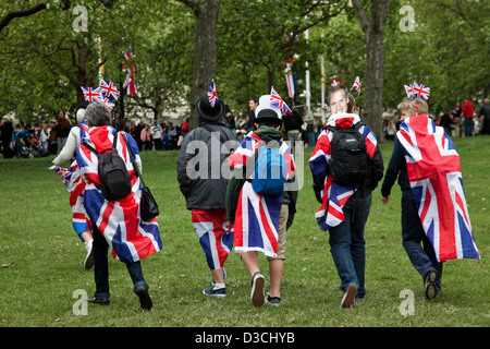 Young men covered in Union Jack are walking through St James' Park during Queen Elisabeth II Diamond Jubilee celebrations Stock Photo