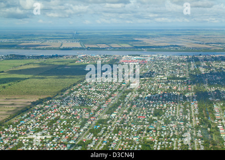 Georgetown, Guyana. Drained marshland alongside the Demerara River, used for alternating residential home estates agriculture. Stock Photo