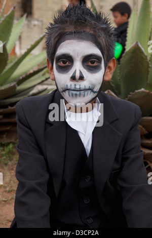 Young boy with face painted as skull at Day of the Dead festival, Oaxaca, Mexico. Stock Photo