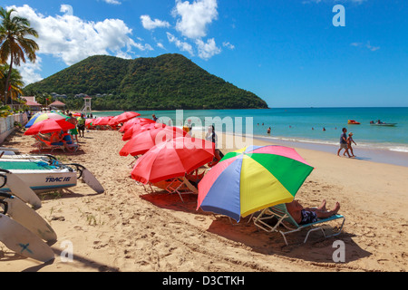 Beach and sunbeds at Rodney Bay at Gros Islet with a view to Mount Pimard, St Lucia Stock Photo