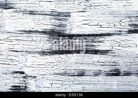 Wooden Panel with cracked paint, black and white craquelure, artificial aging Stock Photo