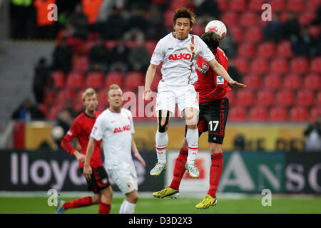 Augsburg's Ja-Cheol Koo (front) vies for the ball with Leverkusen's Sebastian Boenisch (R) during the German Bundesliga soccer match between Bayer 04 Leverkusen and FC Augsburg at BayArena in Leverkusen, Germany, 16 February 2013.  Photo: ROLF VENNENBERND (ATTENTION: EMBARGO CONDITIONS! The DFL permits the further utilisation of up to 15 pictures only (no sequntial pictures or video-similar series of pictures allowed) via the internet and online media during the match (including halftime), taken from inside the stadium and/or prior to the start of the match. The DFL permits the unrestricted tr Stock Photo