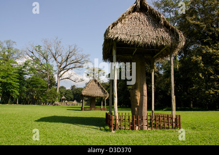 Guatemala, Quirigua Mayan Ruins Archaeological Park (UNESCO), ornately carved stone stele covered by huts. Stock Photo