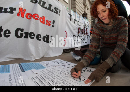Activist making placards outside the Department of Energy & Climate Change office during fuel poverty protest in Whitehall, London, UK, 16th February 2013 Stock Photo