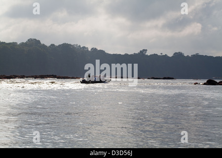 Eco-tourists on an evening motor boat run on the Essequibo River. Rapids ahead. North Rupununi, Guyana. Stock Photo