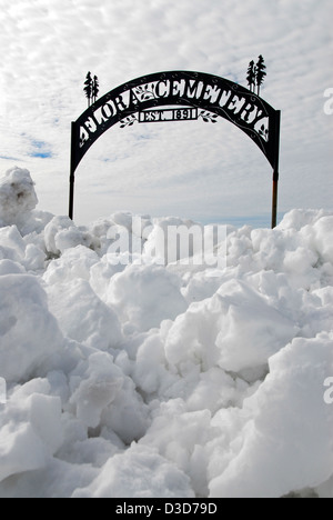 Entrance gate to the Flora Cemetery blocked by snow, Northeast Oregon. Stock Photo