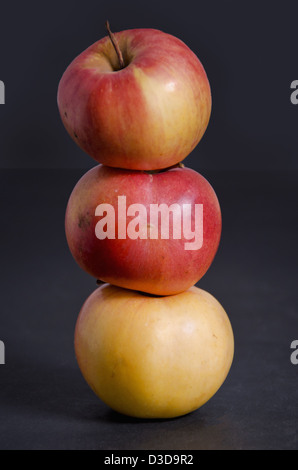 Three apples on dark background Stock Photo