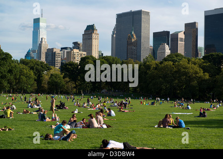 People relaxing in Sheep Meadow, Central Park, on a sunny day. Stock Photo