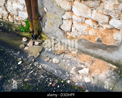 Frost cracked plaster on old stone wall - France. Stock Photo