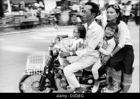 Cambodia: A Cambodian family out for a drive on their Honda in the streets of Phnom Penh. . Stock Photo