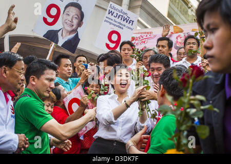 Feb. 17, 2013 - Bangkok, Thailand - Thai Prime Minister YINGLUCK SHINAWATRA accepts roses and talks to voters while campaigning for Pongsapat Pongchareon in Bangkok Sunday. Pol General Pongsapat Pongcharoen, a former deputy national police chief who also served as secretary-general of the Narcotics Control Board is the Pheu Thai Party candidate in the upcoming Bangkok governor's election. (He resigned from the police force to run for Governor.) Former Prime Minister Thaksin Shinawatra reportedly recruited Pongsapat. Most of Thailand's reputable polls have reported that Pongsapat is leading in  Stock Photo