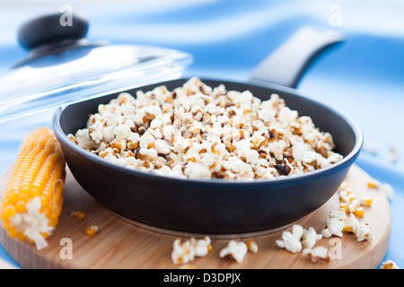 Popcorn cooked in a frying pan and ear of maize, closeup Stock Photo