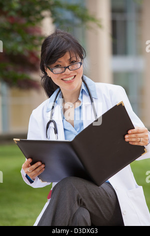 Female doctor studying patient's records Stock Photo
