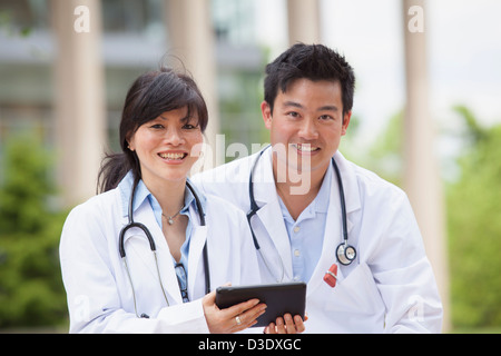 Doctors using a digital tablet Stock Photo