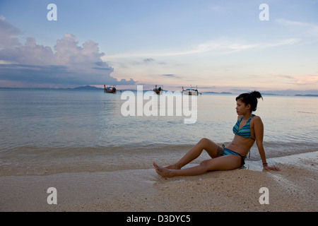 Phi Phi Iceland, Thailand, a woman in a bikini enjoying the evening at the beach Stock Photo