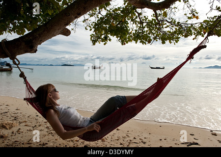 Phi Phi Iceland, Thailand, a woman lies in a hammock on the beach Stock Photo