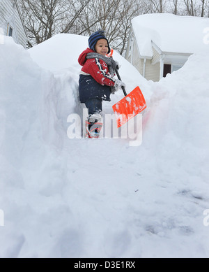 New Haven, CT USA--Kristian Kania, 3, helps out at his home in Westville during the great blizzard NEMO in 2013. Stock Photo