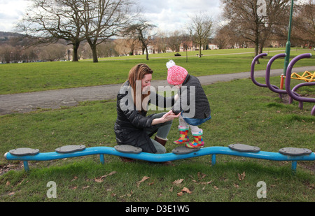 Mum and toddler playing in the park in the winter, UK Stock Photo