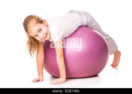 Sportive girl on a fit ball jumping isolated on white Stock Photo