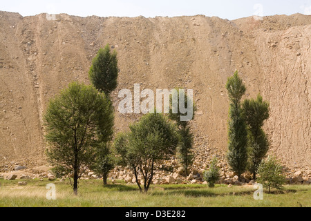 SHANG MAHUANGTOU VILLAGE, SHANXI PROVINCE, CHINA - AUGUST 2007:   An Tai Bao open cast coal mine spoil heap more than 30 meters high and several kilometers long Stock Photo