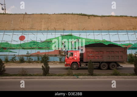 SHANXI PROVINCE, CHINA - AUGUST 2007:  Mural painters at work to beautify the landscape near An Tai Bao, the world's largest open cast coal mine. Stock Photo