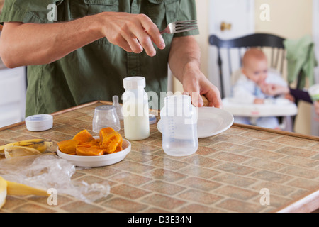 Father preparing baby's meal Stock Photo