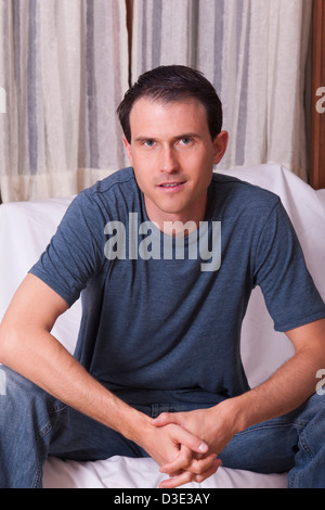 Portrait of a man sitting on a couch Stock Photo